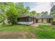 View of the rear exterior, featuring a screened porch and a covered carport area at 1395 Clay Sw Rd, Mableton, GA 30126