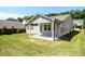 An open backyard with a covered patio offers an ideal space for entertaining, with ample space for outdoor gatherings at 2856 Knob Creek Dr, Snellville, GA 30078