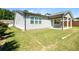 A well-maintained backyard features a covered patio, providing a relaxing outdoor living space with ample grass at 2856 Knob Creek Dr, Snellville, GA 30078