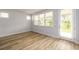 Well-lit bonus room with wood-look flooring, large windows, and a glass door offering outdoor access at 2856 Knob Creek Dr, Snellville, GA 30078