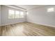 Bedroom with wood-look floors, tray ceiling and large window offering lots of natural light at 2856 Knob Creek Dr, Snellville, GA 30078