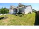 Exterior side view of a gray single-Gathering home, with tidy landscaping and green lawn at 2856 Knob Creek Dr, Snellville, GA 30078