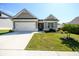 Beautiful single-Gathering home featuring a well-maintained lawn, two-car garage, and tidy landscaping at 2856 Knob Creek Dr, Snellville, GA 30078