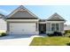 Charming single-Gathering home showcasing a gray facade, two-car garage, and well-manicured lawn at 2856 Knob Creek Dr, Snellville, GA 30078