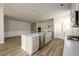 Large kitchen featuring white cabinets, a central island, stainless steel appliances, and a view of the living space at 2856 Knob Creek Dr, Snellville, GA 30078