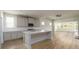 Bright kitchen features white cabinetry, stainless appliances, marble counters, tiled backsplash, and wood-look flooring at 2856 Knob Creek Dr, Snellville, GA 30078