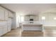 Bright kitchen featuring white cabinets, an island, and modern appliances at 2856 Knob Creek Dr, Snellville, GA 30078