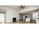Living room with wood-look floors, fireplace, open floorplan to the kitchen featuring white cabinetry at 2856 Knob Creek Dr, Snellville, GA 30078