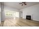Spacious living room features wood-look floors, fireplace, and views to a sunroom with lots of windows at 2856 Knob Creek Dr, Snellville, GA 30078