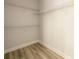 Bright walk-in closet with wire shelving and wood-look flooring at 2856 Knob Creek Dr, Snellville, GA 30078