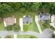 Aerial view showcasing homes with mature trees and a cul-de-sac street at 3932 E Saddle Ridge Dr, Lithonia, GA 30038