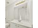Bright bathroom with a vanity, an oversized mirror, updated fixtures, and white cabinets at 3932 E Saddle Ridge Dr, Lithonia, GA 30038
