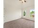 Comfortable bedroom with neutral carpet, a ceiling fan, and two bright windows overlooking the yard at 3932 E Saddle Ridge Dr, Lithonia, GA 30038