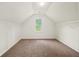 Bright bonus room with neutral carpet, vaulted ceiling, and a window overlooking the yard at 3932 E Saddle Ridge Dr, Lithonia, GA 30038