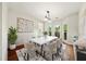Formal dining room with modern chandelier and large bay window at 3932 E Saddle Ridge Dr, Lithonia, GA 30038