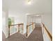 Bright hallway features neutral carpet, white banister, and views to outside at 3932 E Saddle Ridge Dr, Lithonia, GA 30038