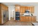 Updated kitchen features stainless steel appliances, wood cabinets, and tile flooring at 3932 E Saddle Ridge Dr, Lithonia, GA 30038