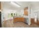 Bright eat-in kitchen with tile flooring, wood cabinets, stainless steel appliances, and backyard view at 3932 E Saddle Ridge Dr, Lithonia, GA 30038