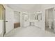 Primary bath with dual sink vanity, tile floor, and open doorway to bedroom at 3932 E Saddle Ridge Dr, Lithonia, GA 30038