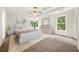 Spacious main bedroom boasts a tray ceiling, plush carpet and windows with tree views at 3932 E Saddle Ridge Dr, Lithonia, GA 30038