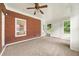 Bright sun room with brick accent wall, neutral carpet, and multiple windows at 3932 E Saddle Ridge Dr, Lithonia, GA 30038