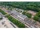 An aerial perspective capturing a train station surrounded by trees, tracks, and urban infrastructure at 178 Wesley Ne Ave # A, Atlanta, GA 30307