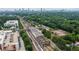 An expansive aerial view showing a train station and green treetops with the cityscape in the distance at 178 Wesley Ne Ave # A, Atlanta, GA 30307