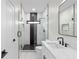 Stylish bathroom with a glass shower, black hardware, and a marble tile accent wall at 178 Wesley Ne Ave # A, Atlanta, GA 30307