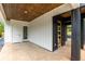 Open-air entryway featuring modern lighting and wood accents, leading to a stylish front door and adjacent white door at 178 Wesley Ne Ave # A, Atlanta, GA 30307