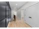Hallway features hardwood floors, dark paneled wall, white trim, and a view of the wooden staircase at 178 Wesley Ne Ave # A, Atlanta, GA 30307