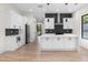 Open concept kitchen with white cabinets, marble counters, stainless appliances, and hardwood floors at 178 Wesley Ne Ave # A, Atlanta, GA 30307