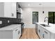 Modern kitchen with white cabinets, black hardware, stainless appliances and statement backsplash at 178 Wesley Ne Ave # A, Atlanta, GA 30307