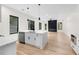 Open concept living space with modern kitchen island, sleek fireplace and hardwood floors at 178 Wesley Ne Ave # A, Atlanta, GA 30307