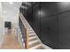 Elegant staircase with wooden treads, black metal railings, and a striking black accent wall at 178 Wesley Ne Ave # A, Atlanta, GA 30307