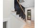 Stylish staircase featuring wood and black metal railing, leading to a bright entryway with a modern front door at 178 Wesley Ne Ave # A, Atlanta, GA 30307