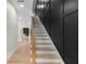 Modern staircase with wooden treads, black metal railings, and an accent wall, leading to the home's entry at 178 Wesley Ne Ave # A, Atlanta, GA 30307