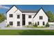 Stunning modern two-story home featuring white brick, black trim, and professional landscaping at 2797 Benson Dr, Marietta, GA 30062