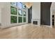 Open-concept living area featuring hardwood floors, a fireplace, and a modern lighting fixture at 2797 Benson Dr, Marietta, GA 30062