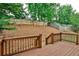 Backyard featuring a wood deck, wood fence, and a sloped yard covered with pine straw at 2956 Silver Hill Se Ter, Atlanta, GA 30316