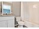 Bathroom featuring tiled floors, white vanity, shower/tub with white tiled surround at 2956 Silver Hill Se Ter, Atlanta, GA 30316