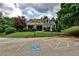 Community clubhouse with accessible parking, manicured lawn, mature trees, and inviting covered porch at 2956 Silver Hill Se Ter, Atlanta, GA 30316