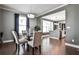 Elegant dining room with dark wood floors, modern lighting, and open layout to kitchen at 2956 Silver Hill Se Ter, Atlanta, GA 30316