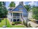 Exterior view of a two-story home with a welcoming front porch and well-maintained landscaping at 2956 Silver Hill Se Ter, Atlanta, GA 30316
