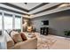 Spacious main bedroom with tray ceiling, sitting area, large windows, and neutral carpet at 2956 Silver Hill Se Ter, Atlanta, GA 30316
