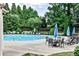 Community pool with lounge chairs, tables, umbrellas, and mature landscaping for a relaxing experience at 2956 Silver Hill Se Ter, Atlanta, GA 30316
