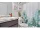 Bathroom with decorative shower curtain, floral artwork, and a sleek sink and vanity at 3143 Bonnes Dr, Stonecrest, GA 30038