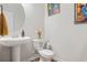 Bathroom with a pedestal sink and a decorated toilet at 3143 Bonnes Dr, Stonecrest, GA 30038