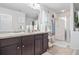 Bathroom with double vanity, granite countertops, and a glass-enclosed shower at 3143 Bonnes Dr, Stonecrest, GA 30038