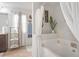 Bright bathroom featuring a large soaking tub and a stylish storage shelf near the vanity at 3143 Bonnes Dr, Stonecrest, GA 30038