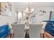Bright dining area with modern chandelier, a marble table and natural lighting at 3143 Bonnes Dr, Stonecrest, GA 30038